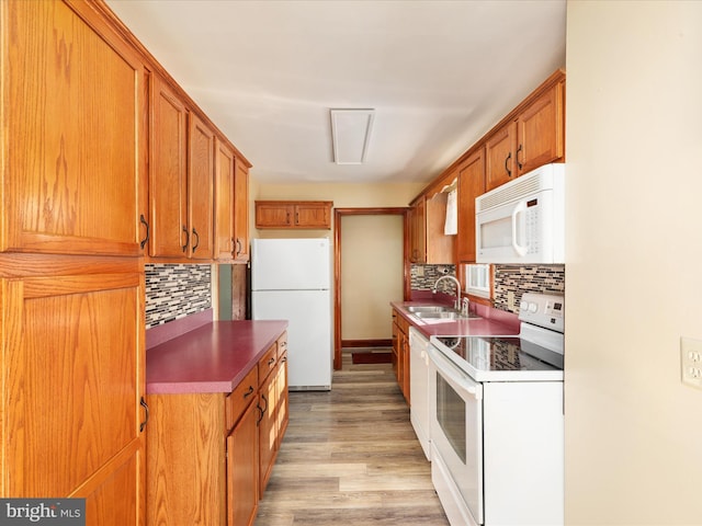 55 W Duck St, Front Royal, VA 22630 - kitchen with white appliances, decorative backsplash, light wood-type flooring, brown cabinets, and dark countertops