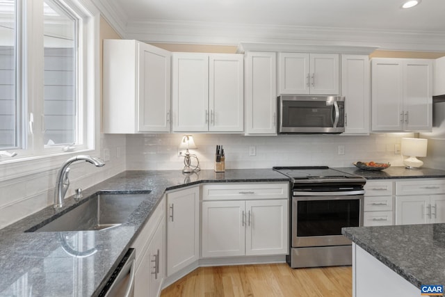 109 Stonecrest Ave, Waynesboro, VA 22980 - kitchen featuring appliances with stainless steel finishes, white cabinets, tasteful backsplash, light wood-type flooring, and dark stone counters