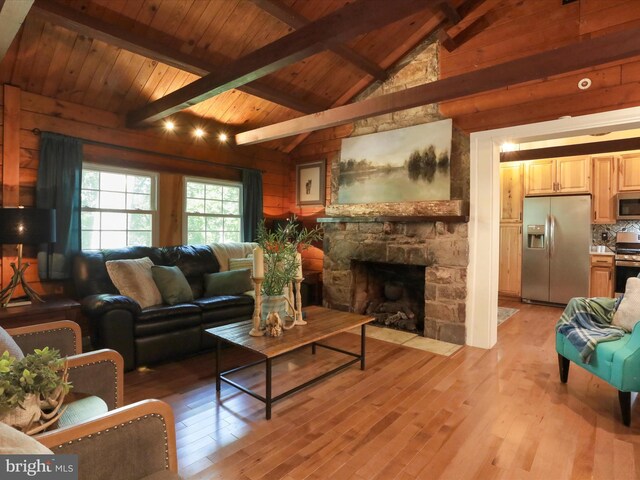 832 Shenandoah River Dr, Harpers Ferry, WV 25425 - living area featuring light wood-type flooring, a stone fireplace, wood ceiling, and wood walls