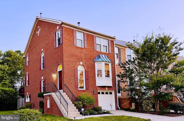 8001 Gina Pl, Vienna, VA 22182 - townhome / multi-family property featuring a garage, brick siding, and driveway