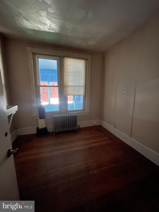 3831 N 19th St, Philadelphia, PA 19140 - empty room with radiator and wood finished floors
