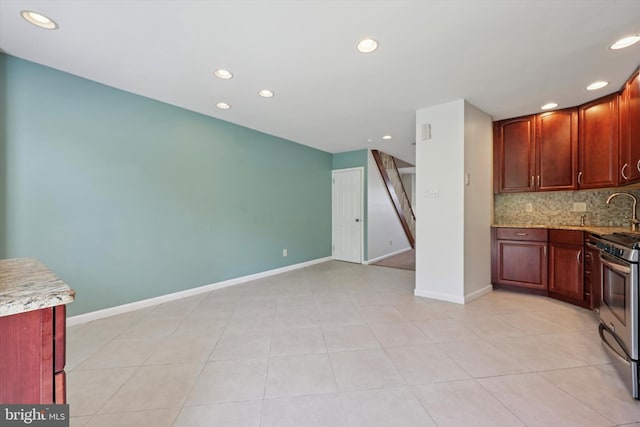 260 Rock St, Philadelphia, PA 19128 - kitchen featuring stainless steel gas range oven, recessed lighting, tasteful backsplash, and light tile patterned flooring