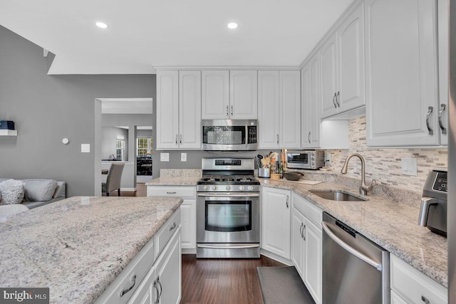 506 Masters Dr, Blackwood, NJ 08012 - kitchen featuring appliances with stainless steel finishes, white cabinetry, light stone countertops, dark wood-style flooring, and recessed lighting