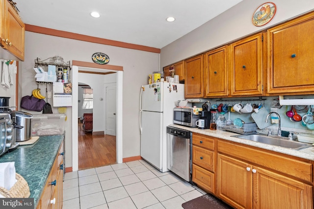 5563 Loretto Ave, Philadelphia, PA 19124 - kitchen featuring stainless steel appliances, brown cabinets, light tile patterned flooring, arched walkways, and recessed lighting