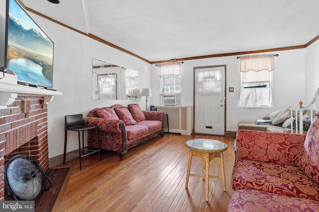 5563 Loretto Ave, Philadelphia, PA 19124 - living room with ornamental molding, radiator, hardwood / wood-style flooring, cooling unit, and a brick fireplace