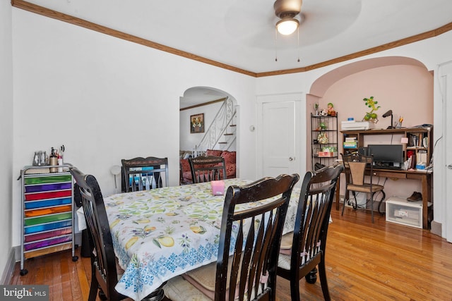 5563 Loretto Ave, Philadelphia, PA 19124 - dining space featuring arched walkways, wood-type flooring, ceiling fan, and ornamental molding