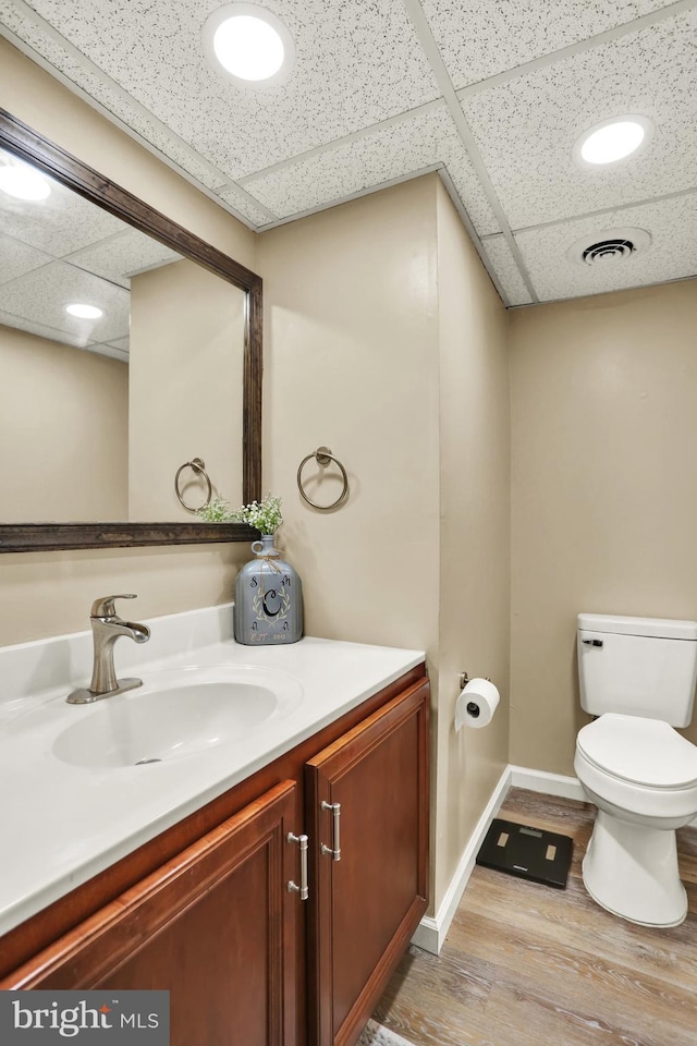 28 Wister Way, Reading, PA 19606 - half bathroom with a paneled ceiling, vanity, and wood finished floors
