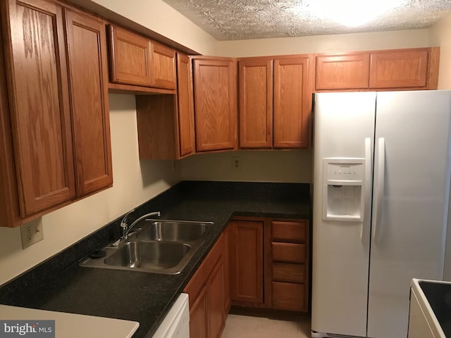 426 Shady Glen Dr, Capitol Heights, MD 20743 - kitchen with white appliances, brown cabinets, and dark countertops