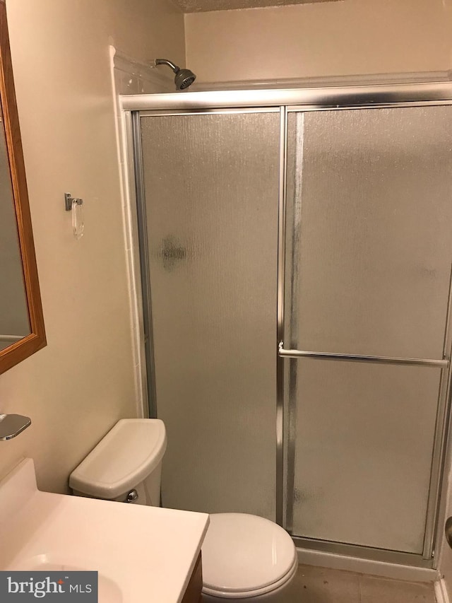 426 Shady Glen Dr, Capitol Heights, MD 20743 - full bathroom featuring vanity, a stall shower, and tile patterned flooring