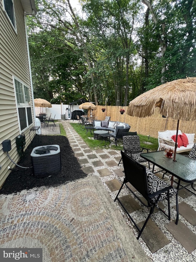 44 Meadowrue Ln, Sicklerville, NJ 08081 - fenced backyard featuring outdoor lounge area, a patio area, and outdoor dining space