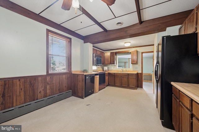 1102 Walnut, Collingdale, PA 19023 - kitchen featuring black appliances, a baseboard radiator, a ceiling fan, wainscoting, and light countertops