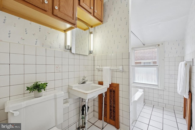 1102 Walnut, Collingdale, PA 19023 - full bathroom with wallpapered walls, tile walls, a garden tub, tile patterned floors, and wainscoting