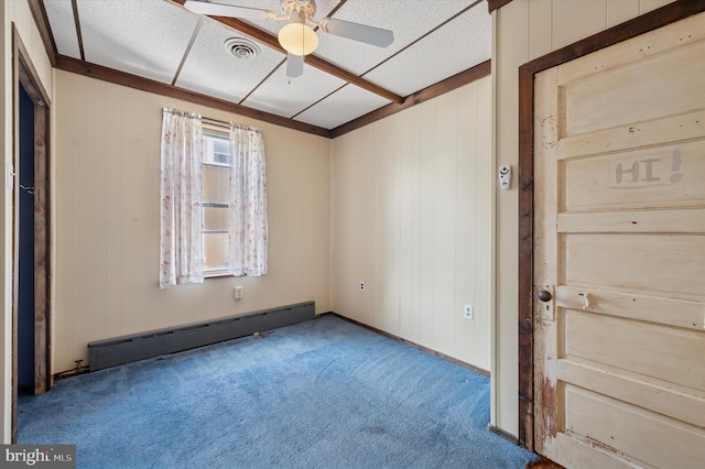 1102 Walnut, Collingdale, PA 19023 - carpeted spare room with a baseboard radiator, a ceiling fan, and wood walls