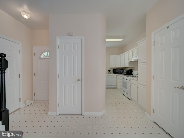 7317 Jubilee Cir, Elkridge, MD 21075 - kitchen with white appliances, under cabinet range hood, light flooring, and white cabinets