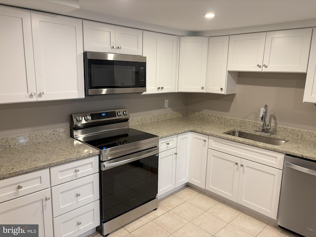 1708 Granite Ct, Crofton, MD 21114 - kitchen featuring appliances with stainless steel finishes, white cabinetry, light tile patterned floors, light stone counters, and recessed lighting