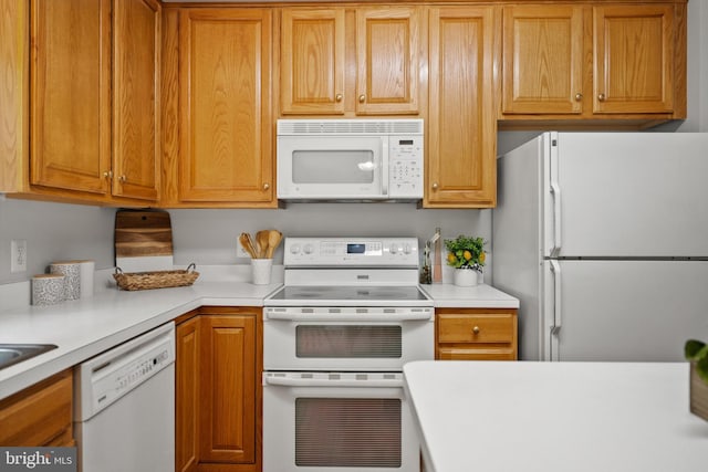 14908 Slippery Elm Ct, Woodbridge, VA 22193 - kitchen with white appliances, light countertops, and brown cabinets