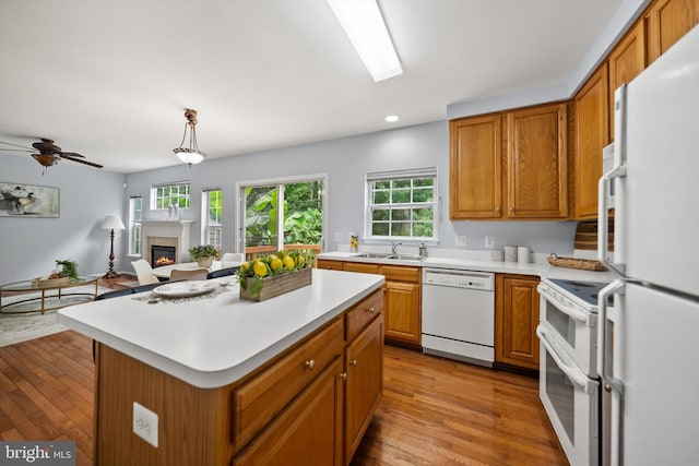14908 Slippery Elm Ct, Woodbridge, VA 22193 - kitchen with white appliances, light countertops, wood finished floors, brown cabinetry, and recessed lighting