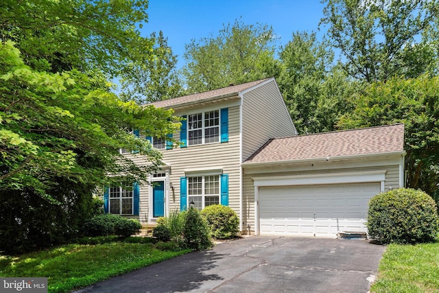 14908 Slippery Elm Ct, Woodbridge, VA 22193 - colonial house with asphalt driveway, an attached garage, and a shingled roof
