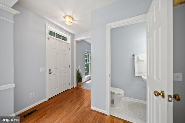 14908 Slippery Elm Ct, Woodbridge, VA 22193 - entryway with baseboards and light wood-type flooring