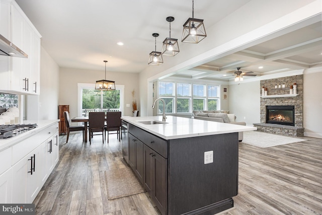 1311 Corbett Rd, Monkton, MD 21111 - kitchen with stainless steel appliances, white cabinets, light wood-type flooring, light countertops, and beam ceiling