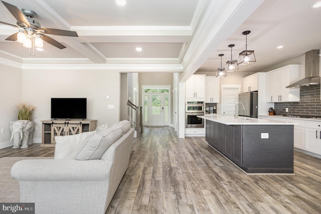 1311 Corbett Rd, Monkton, MD 21111 - kitchen with wall chimney exhaust hood, appliances with stainless steel finishes, crown molding, a ceiling fan, and open floor plan