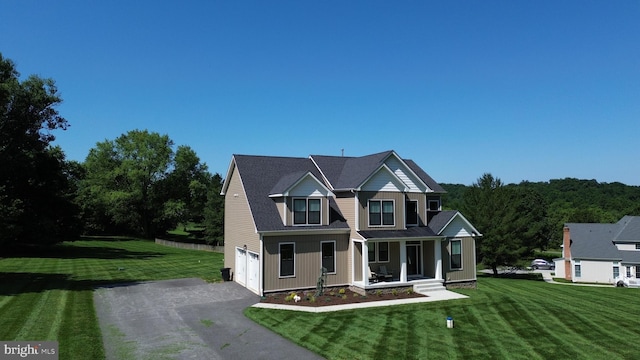 1311 Corbett Rd, Monkton, MD 21111 - traditional-style house featuring asphalt driveway, covered porch, an attached garage, and a front lawn
