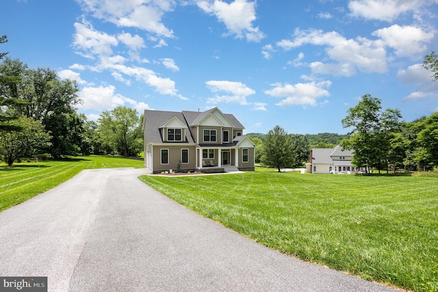 1311 Corbett Rd, Monkton, MD 21111 - view of front facade featuring covered porch, a front lawn, and view of wooded area