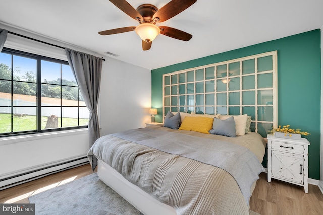 2333 Sunset Cir, Glenville, PA 17329 - bedroom featuring baseboard heating, wood finished floors, and ceiling fan