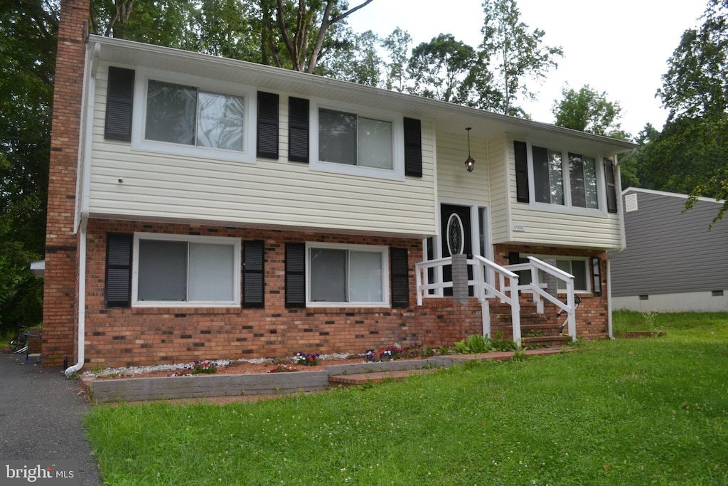 11002 Meadowlark Ln, Spotsylvania, VA 22553 - split foyer home featuring a front lawn, brick siding, and a chimney