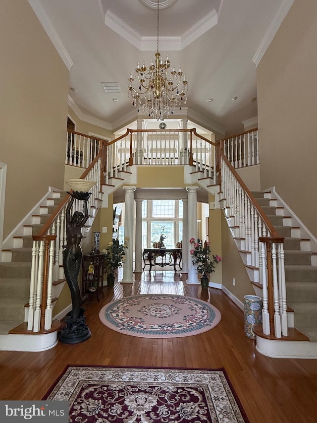 12211 Garrison Forest Rd, Owings Mills, MD 21117 - foyer with wood finished floors, stairs, a chandelier, crown molding, and a towering ceiling