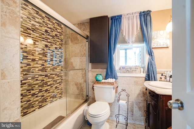 7723 Meath Rd, Baltimore, MD 21222 - bathroom featuring vanity, tile walls, and shower / bath combination with glass door