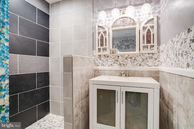 7723 Meath Rd, Baltimore, MD 21222 - bathroom with a tile shower, vanity, and tile walls