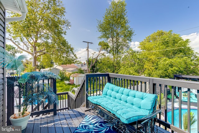 7723 Meath Rd, Baltimore, MD 21222 - wooden deck featuring a storage unit and an outdoor pool