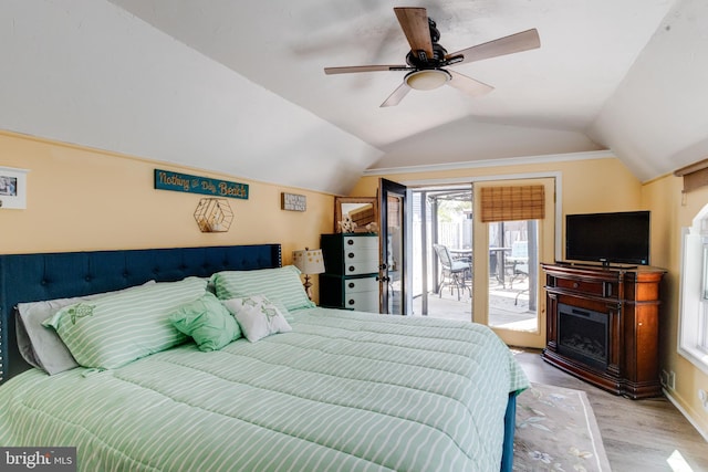 7723 Meath Rd, Baltimore, MD 21222 - bedroom featuring access to outside, vaulted ceiling, wood finished floors, a ceiling fan, and a fireplace