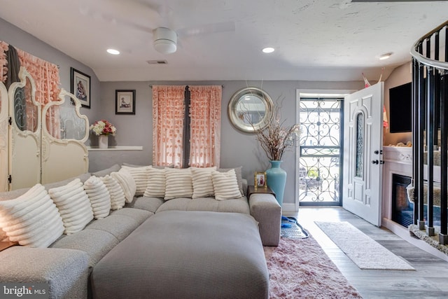 7723 Meath Rd, Baltimore, MD 21222 - living area with wood finished floors, recessed lighting, and a glass covered fireplace