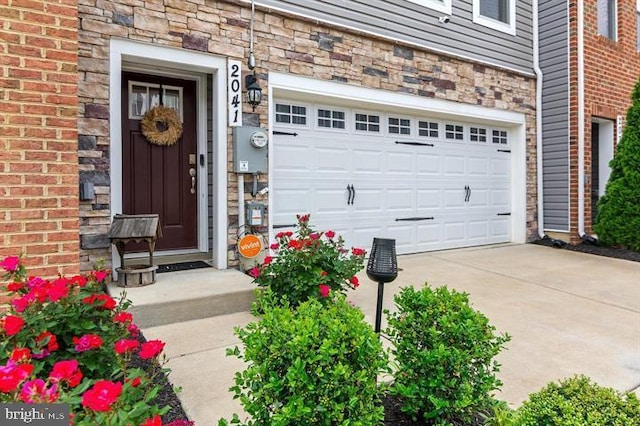 2041 Ruby Turn, Bowie, MD 20721 - property entrance featuring stone siding, concrete driveway, and an attached garage