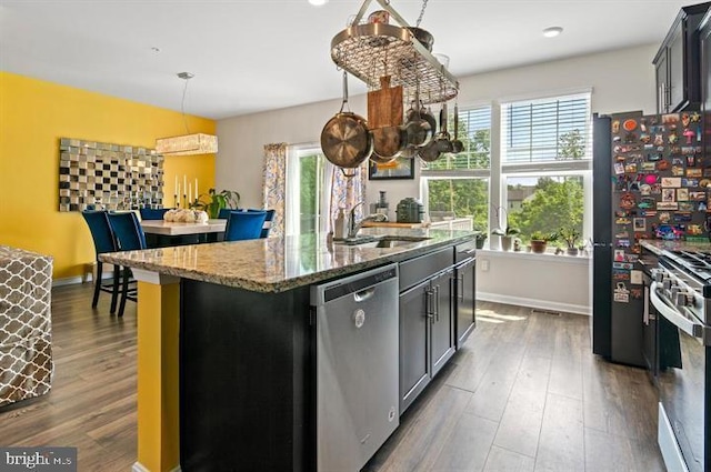 2041 Ruby Turn, Bowie, MD 20721 - kitchen featuring appliances with stainless steel finishes, light stone counters, dark wood finished floors, a kitchen island with sink, and pendant lighting