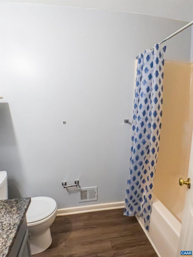 5553 Brookwood Rd, Crozet, VA 22932 - full bath featuring vanity, wood finished floors, and shower / bath combo with shower curtain