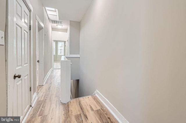 2710 The Alameda, Baltimore, MD 21218 - corridor featuring light wood-style flooring and an upstairs landing