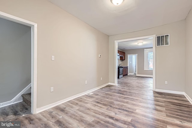 2710 The Alameda, Baltimore, MD 21218 - unfurnished living room with dark wood finished floors and stairs