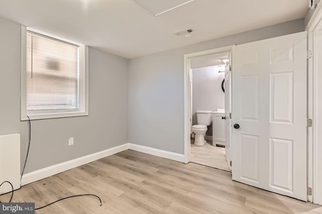 3401 Woodring Ave, Baltimore, MD 21234 - unfurnished bedroom with light wood-style flooring and connected bathroom