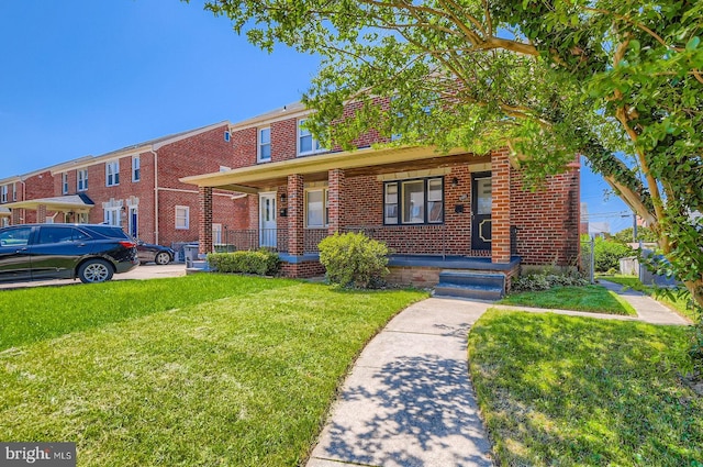 3401 Woodring Ave, Baltimore, MD 21234 - view of front facade with covered porch, brick siding, and a front yard