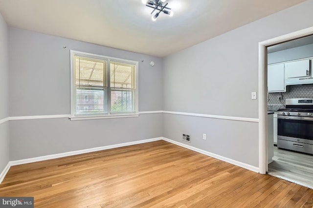 3401 Woodring Ave, Baltimore, MD 21234 - unfurnished dining area with light wood-style flooring and baseboards