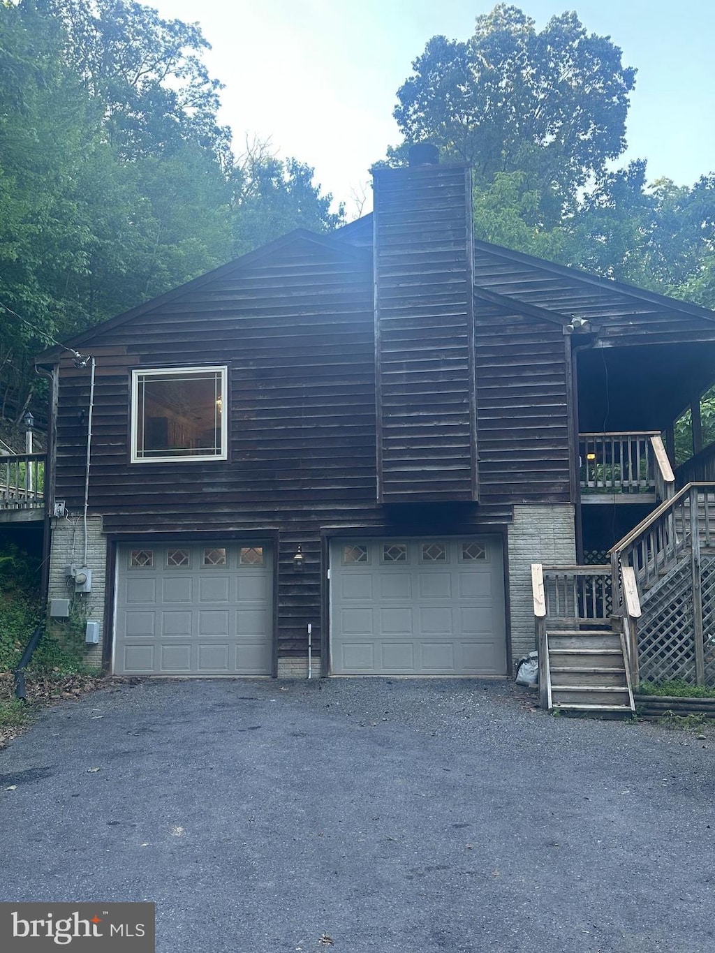 2702 Rodgers Ter, Haymarket, VA 20169 - view of side of home with brick siding, stairs, a chimney, and driveway