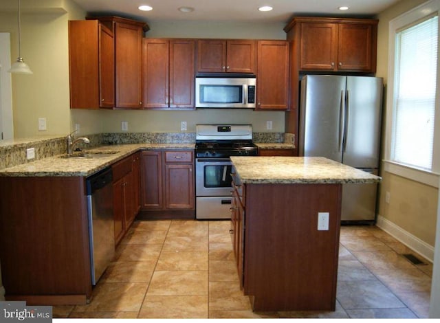 2803 Berwick Ave, Baltimore, MD 21234 - kitchen with stainless steel appliances, light stone counters, recessed lighting, a center island, and hanging light fixtures