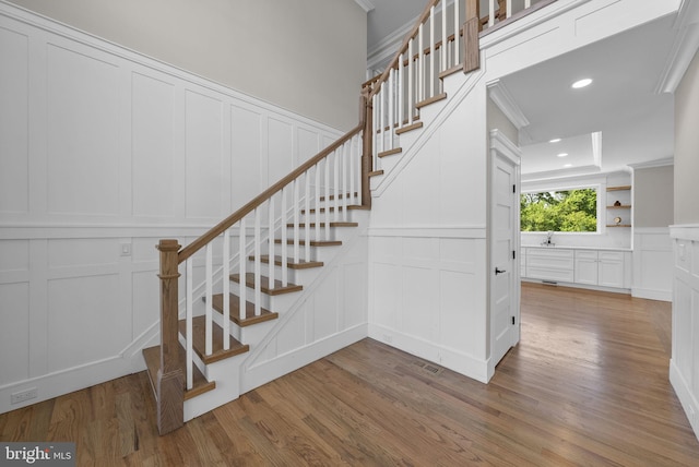 387 Gallup Rd, Princeton, NJ 08540 - stairs featuring a decorative wall, wood finished floors, ornamental molding, recessed lighting, and a wainscoted wall