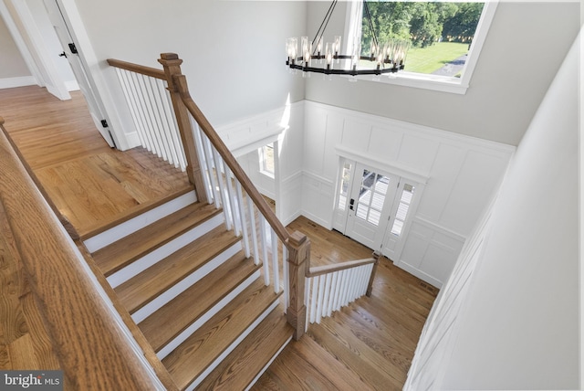 387 Gallup Rd, Princeton, NJ 08540 - staircase with a decorative wall, a chandelier, wainscoting, and wood finished floors