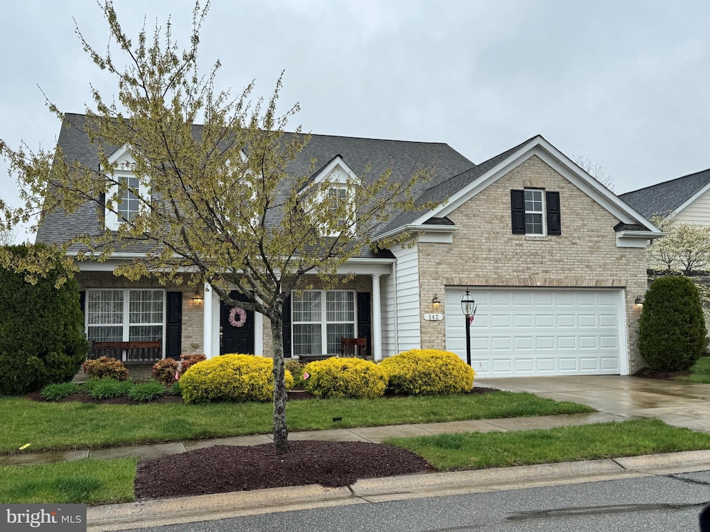 142 Harmony Way, Centreville, MD 21617 - view of front of property with an attached garage, driveway, brick siding, and roof with shingles