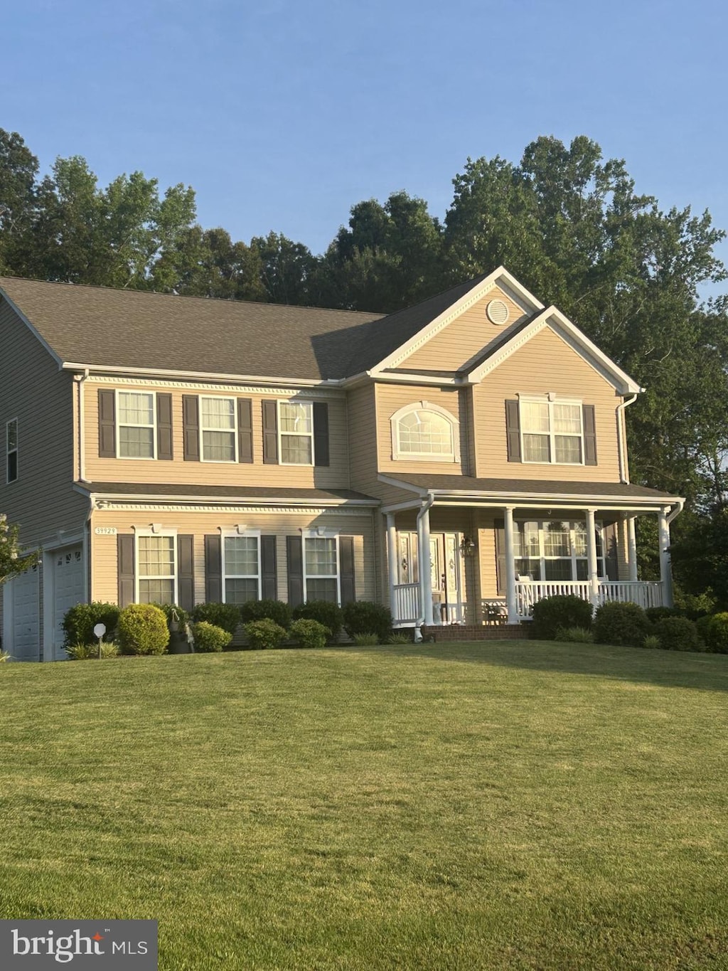 39929 Grandview Haven Dr, Mechanicsville, MD 20659 - view of front facade with covered porch, a front lawn, and an attached garage