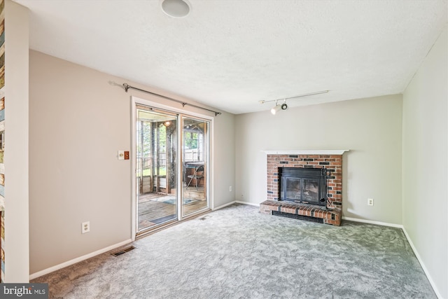 376 Jamie Ct, Glen Burnie, MD 21060 - unfurnished living room featuring carpet floors, a fireplace, and a textured ceiling